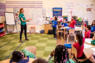 Emily Reckard teaching a lesson to kids in a classroom