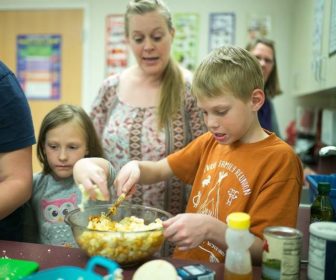 Family members prepare a healthy taco dinner at the junior high