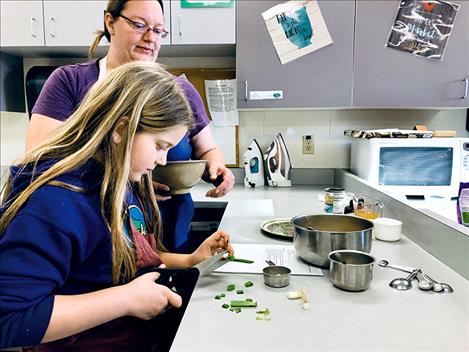 Students prepare healthy food as part of an initiative by the Polson School District Wellness Committee