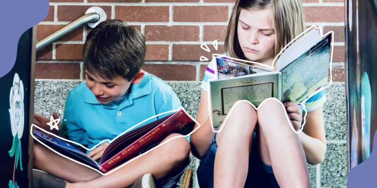 Two kids sitting on playground equipment and reading books. One is smiling and looking down, while the other looks intently at the book.