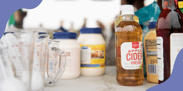 An array of condiments and sauces, some ultraprocessed and some not, standing on a white table in bright outdoor light.